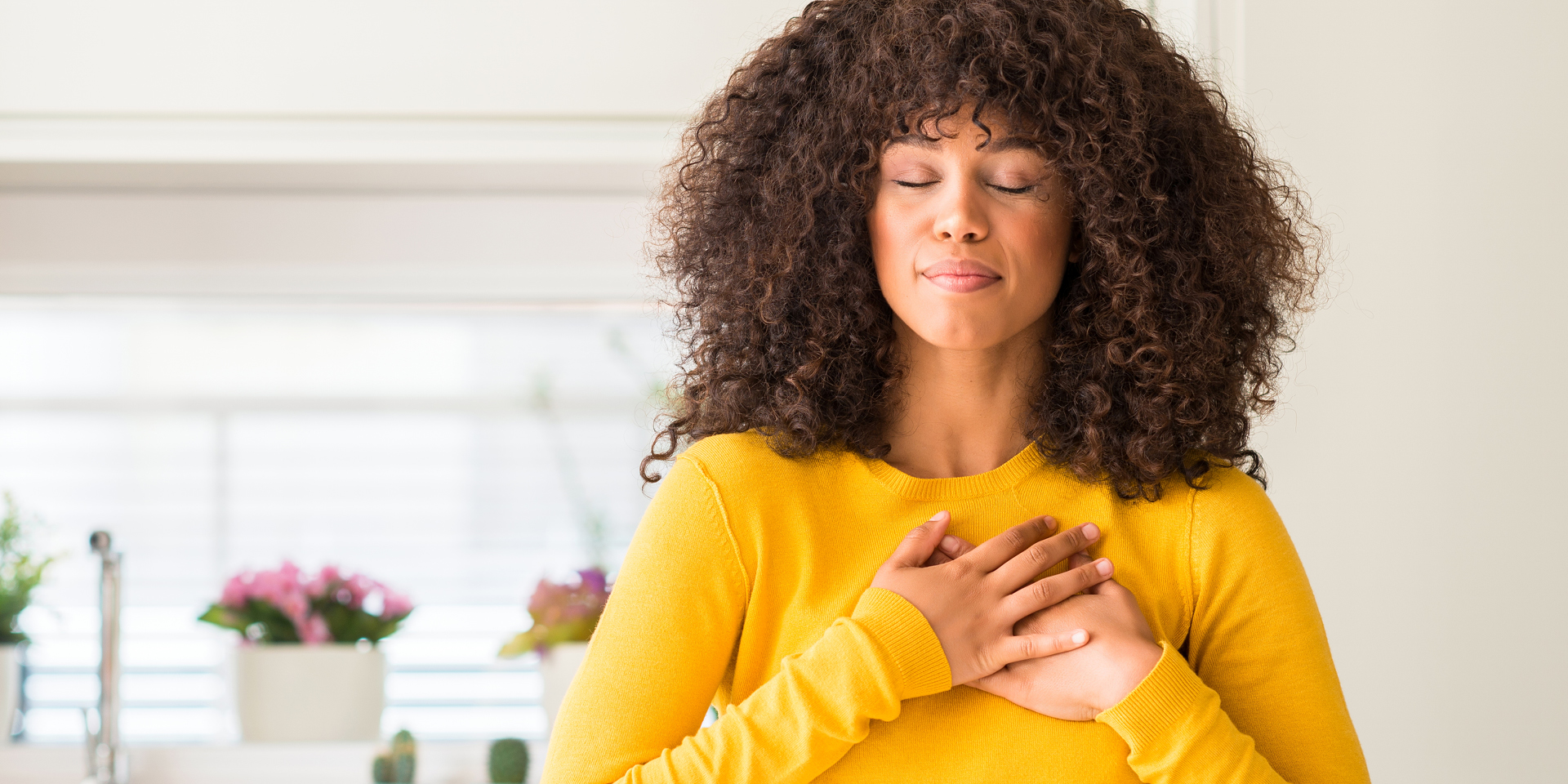 Woman hands on heart eyes closed