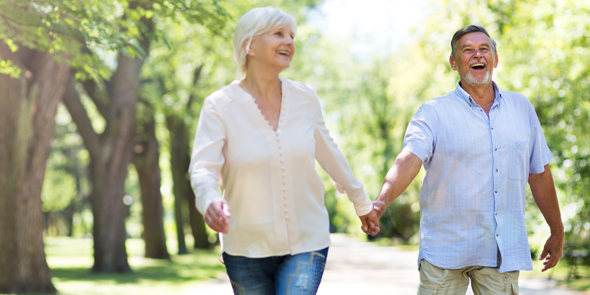 Man and woman happily walking in park