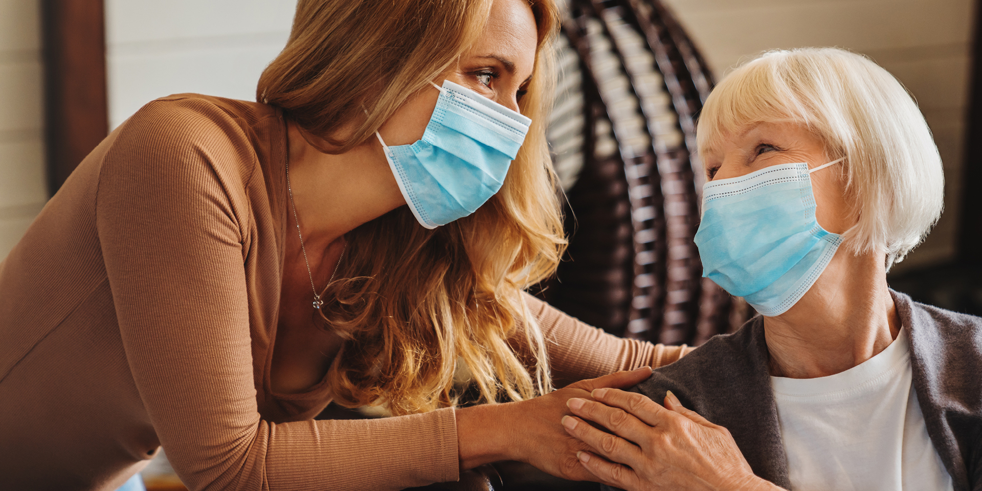 Younger woman with hand on shoulder of older woman